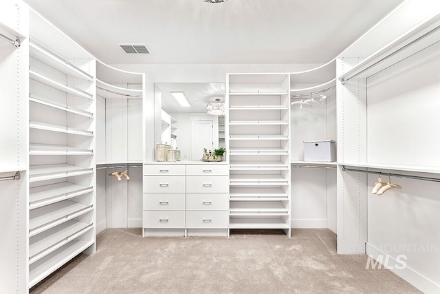 walk in closet with light colored carpet and visible vents