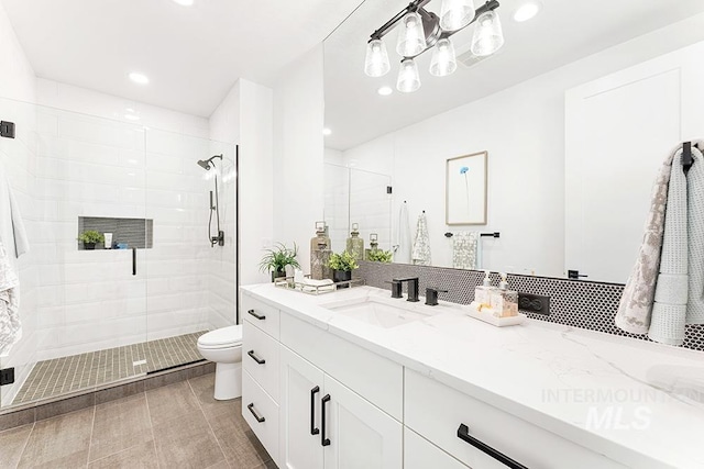 bathroom with a stall shower, vanity, toilet, and recessed lighting