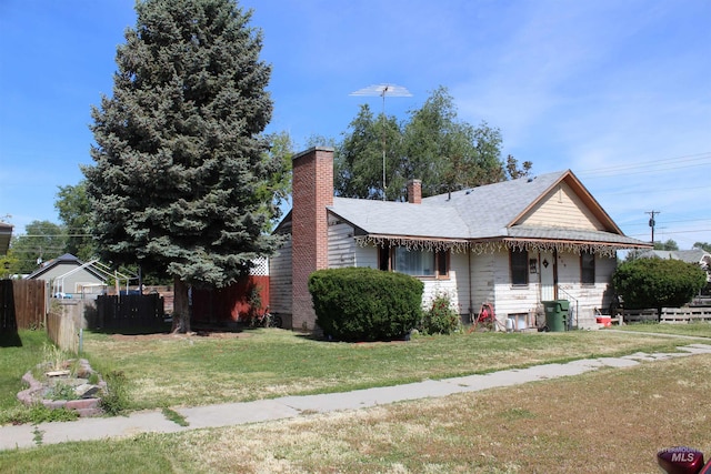 bungalow-style home with a front yard