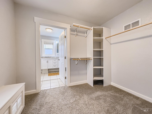 spacious closet featuring light carpet and visible vents