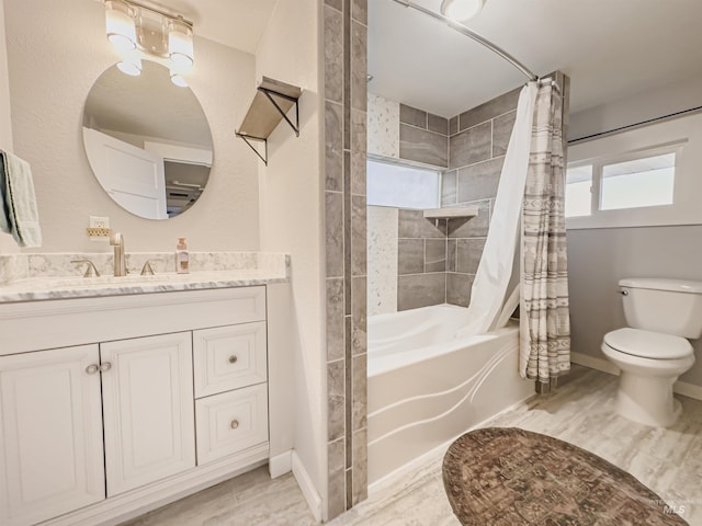 full bathroom featuring toilet, shower / bathtub combination with curtain, wood finished floors, and vanity