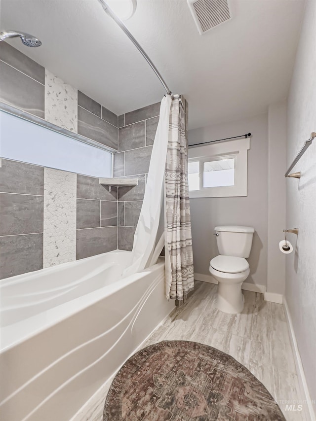 bathroom with baseboards, shower / bath combination with curtain, visible vents, and toilet