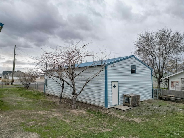 view of outbuilding with an outbuilding and fence