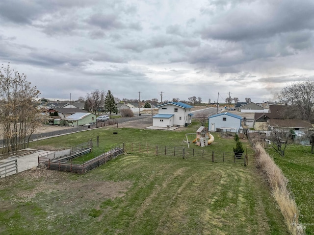 view of yard with a garden, a playground, and fence