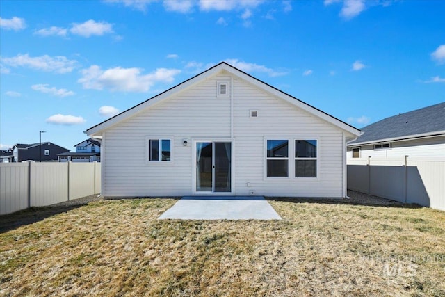 back of house featuring a patio area, a fenced backyard, and a yard