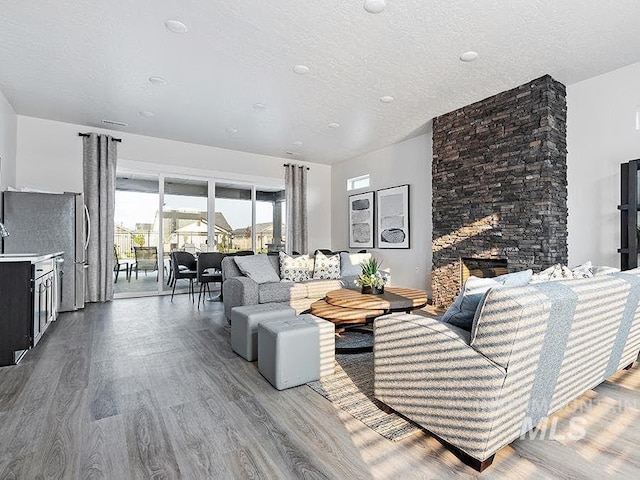 living area featuring a textured ceiling and wood finished floors