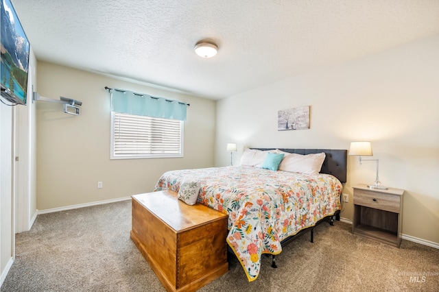 bedroom featuring carpet flooring, a textured ceiling, and baseboards