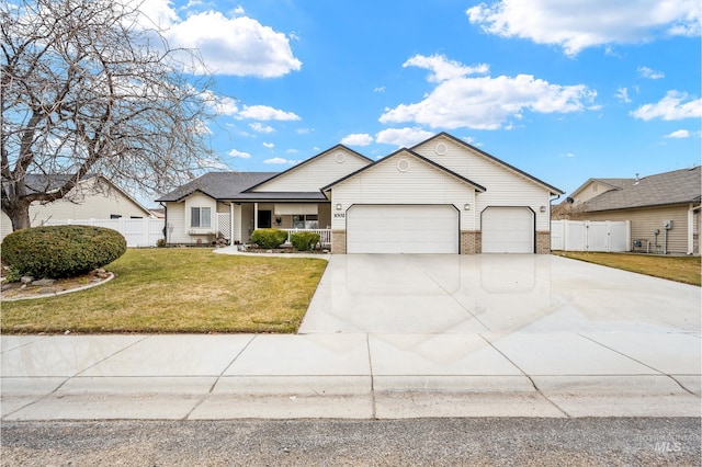 view of front facade featuring brick siding, an attached garage, a front yard, fence, and driveway