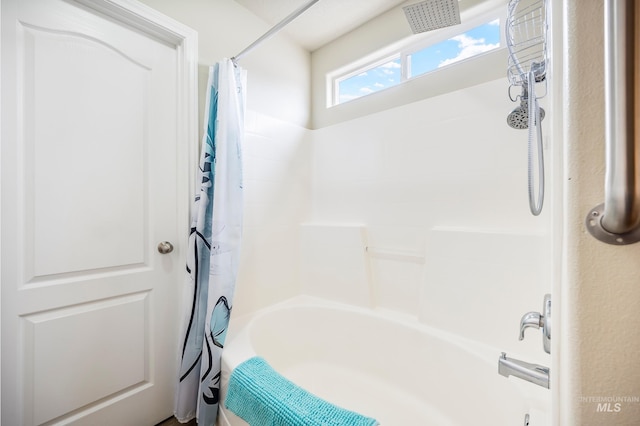 bathroom with shower / bath combo with shower curtain