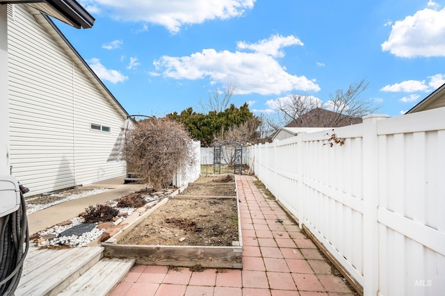 view of yard with a fenced backyard and a vegetable garden