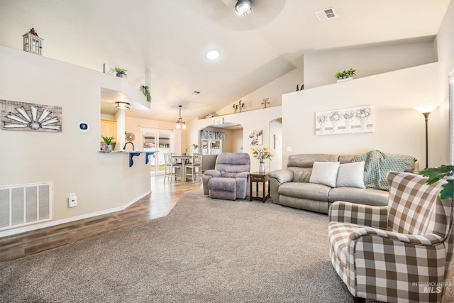 living room featuring carpet floors, arched walkways, visible vents, and high vaulted ceiling