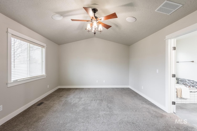 unfurnished room with visible vents, baseboards, vaulted ceiling, carpet flooring, and a ceiling fan