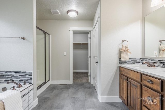 full bathroom featuring a garden tub, vanity, backsplash, and a shower stall