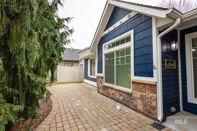 view of patio featuring visible vents and fence