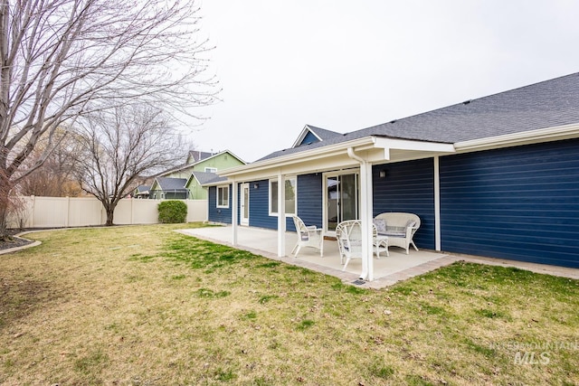 back of house featuring a patio area, a yard, and fence