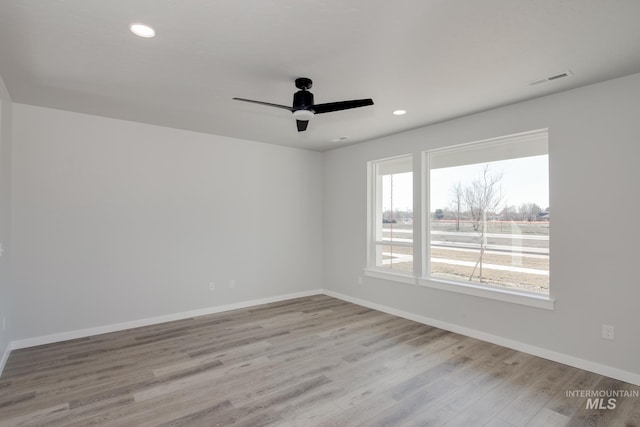 unfurnished room featuring ceiling fan and light hardwood / wood-style floors