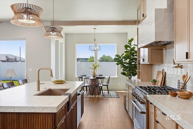 507 Falling Leaf Ln, Twin Falls, ID 83301 - kitchen featuring stainless steel appliances, dark wood-type flooring, wall chimney exhaust hood, tasteful backsplash, and hanging light fixtures