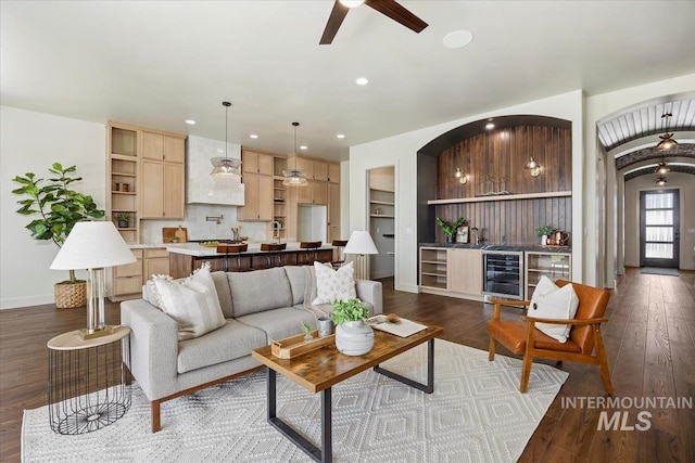 507 Falling Leaf Ln, Twin Falls, ID 83301 - living area featuring wine cooler, ceiling fan, bar, dark wood-style flooring, and recessed lighting