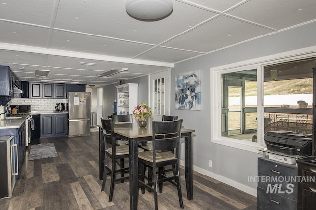 dining area with dark wood-style floors and baseboards