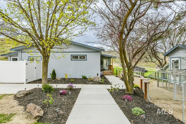 view of property exterior featuring fence and a gate