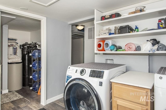 washroom featuring washer / clothes dryer, dark wood-type flooring, visible vents, and baseboards