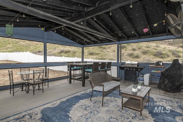 deck featuring a grill, outdoor dining area, and fence