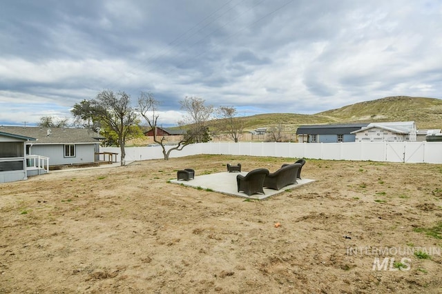 entry to storm shelter with a mountain view, fence, and a patio area