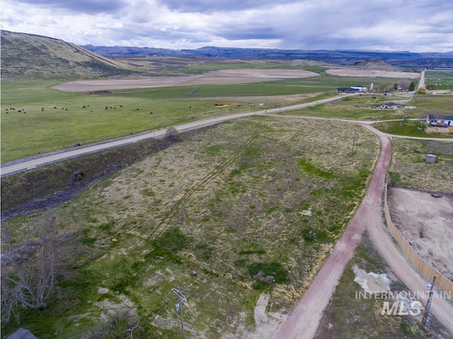 birds eye view of property with a rural view and a mountain view