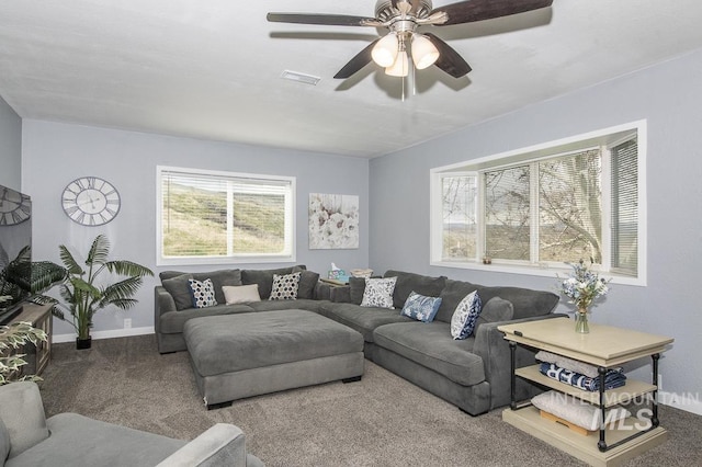 carpeted living area with ceiling fan, baseboards, and visible vents