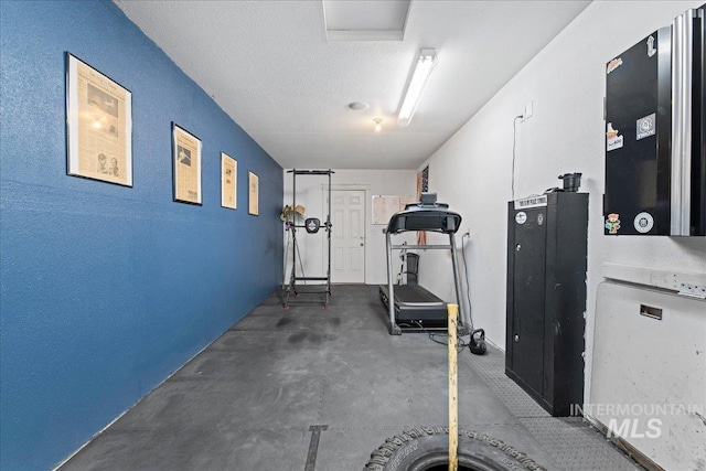 exercise area featuring a textured ceiling