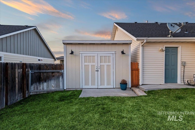 view of shed featuring fence