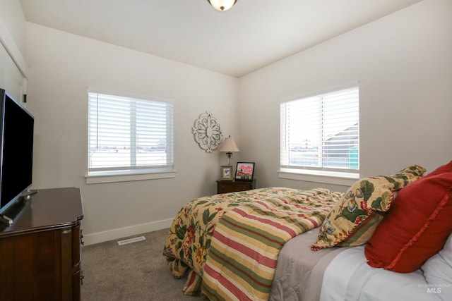 carpeted bedroom with visible vents and baseboards