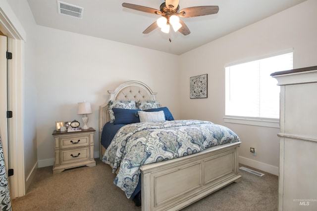 bedroom with baseboards, visible vents, and light colored carpet