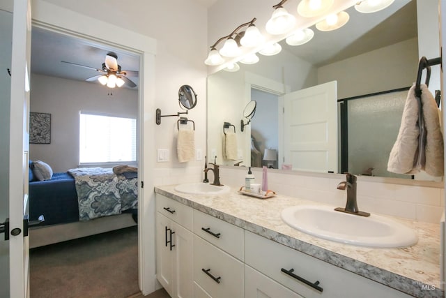 bathroom with a sink, decorative backsplash, and connected bathroom