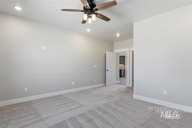 unfurnished room featuring recessed lighting, light colored carpet, baseboards, and ceiling fan