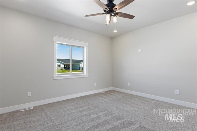 spare room with light colored carpet, a ceiling fan, visible vents, recessed lighting, and baseboards