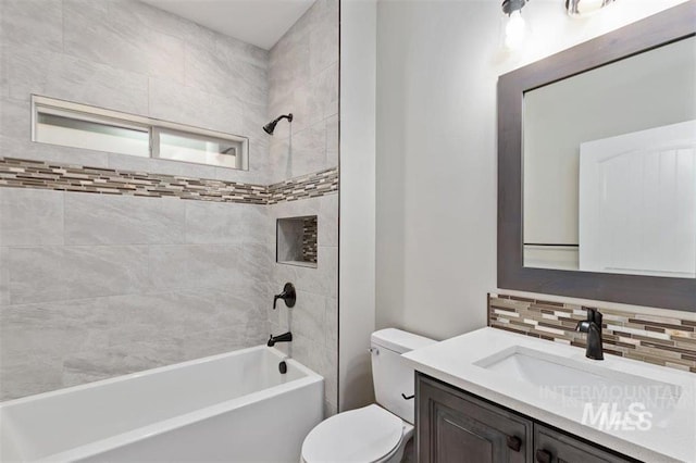 full bath with backsplash, toilet, vanity, and  shower combination