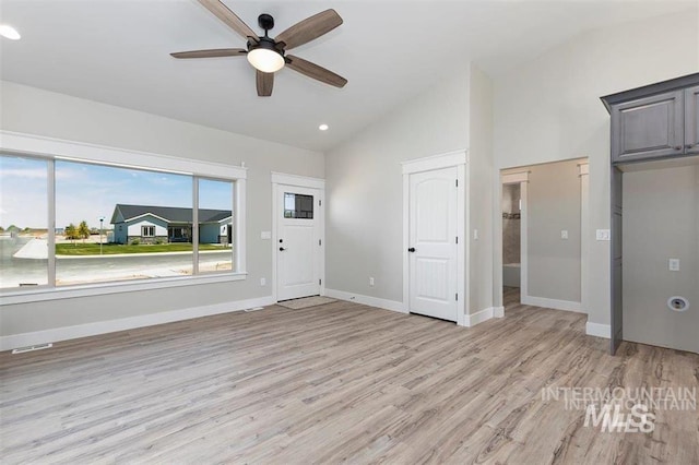 unfurnished living room with lofted ceiling, visible vents, light wood-type flooring, and ceiling fan