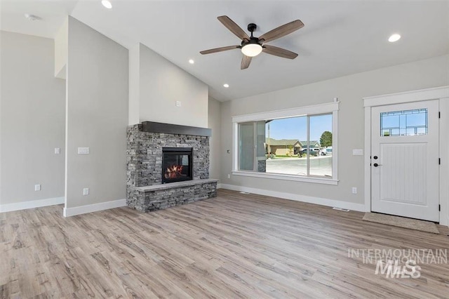 unfurnished living room with wood finished floors, ceiling fan, baseboards, and lofted ceiling