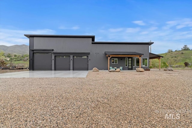 garage with driveway and a mountain view