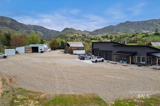 view of asphalt driveway featuring a mountain view