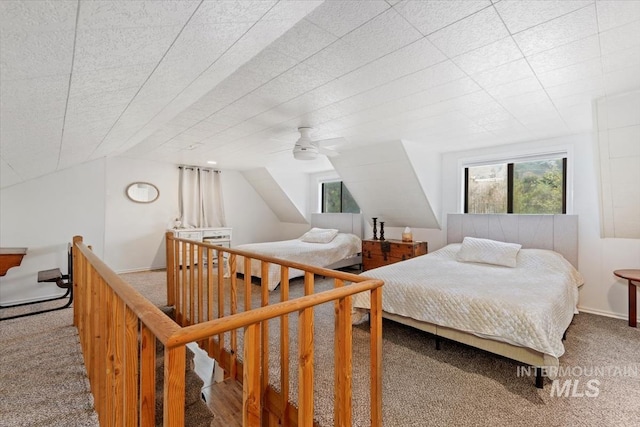 bedroom with carpet flooring, vaulted ceiling, and a ceiling fan