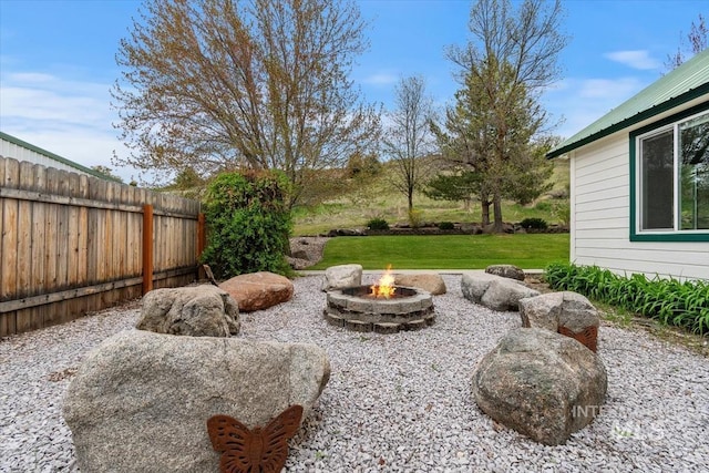 view of yard with a fire pit
