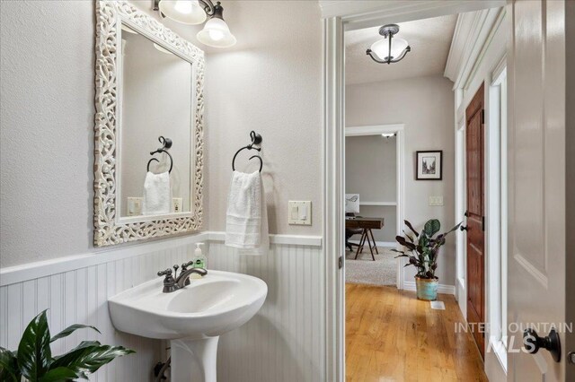 4824 S Longmoor Ave, Boise, ID 83709 - bathroom featuring a sink, wainscoting, and wood finished floors