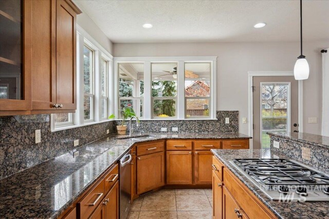 4824 S Longmoor Ave, Boise, ID 83709 - kitchen featuring ceiling fan, brown cabinetry, tasteful backsplash, appliances with stainless steel finishes, and a sink