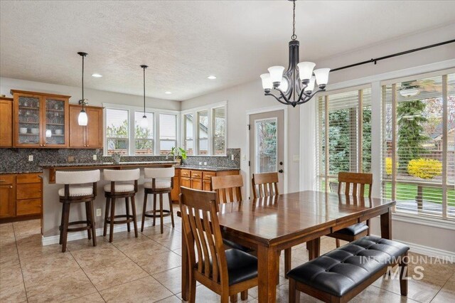 4824 S Longmoor Ave, Boise, ID 83709 - dining space featuring a chandelier, a textured ceiling, light tile patterned floors, and recessed lighting