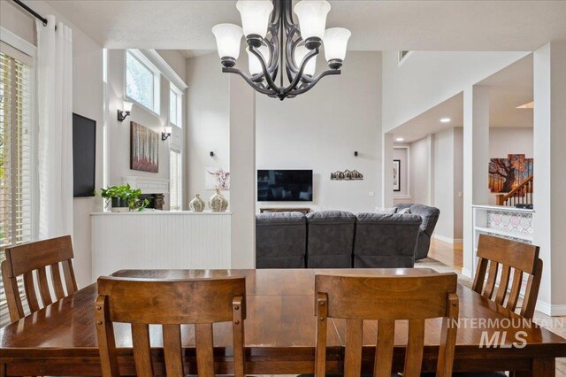 4824 S Longmoor Ave, Boise, ID 83709 - dining area with a high ceiling and a notable chandelier