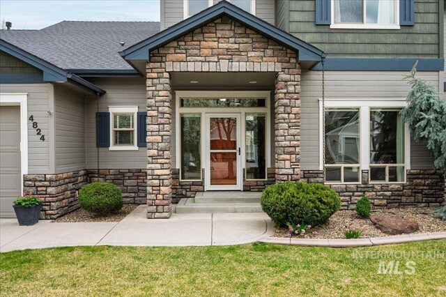 4824 S Longmoor Ave, Boise, ID 83709 - property entrance with roof with shingles, a chimney, and stone siding