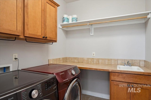4824 S Longmoor Ave, Boise, ID 83709 - laundry room featuring independent washer and dryer, tile patterned floors, a sink, and cabinet space
