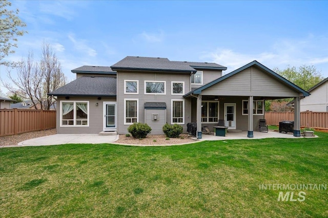 4824 S Longmoor Ave, Boise, ID 83709 - back of house featuring a patio area, fence, a shingled roof, and a yard
